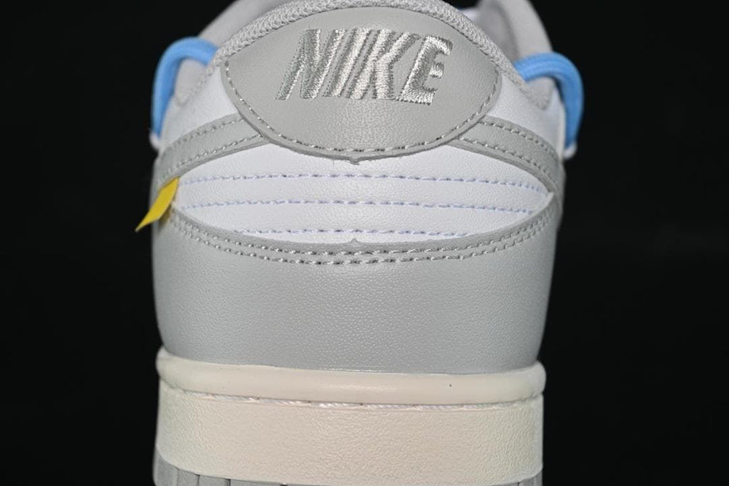 Rear view of the white and grey sneaker with Nike heel branding