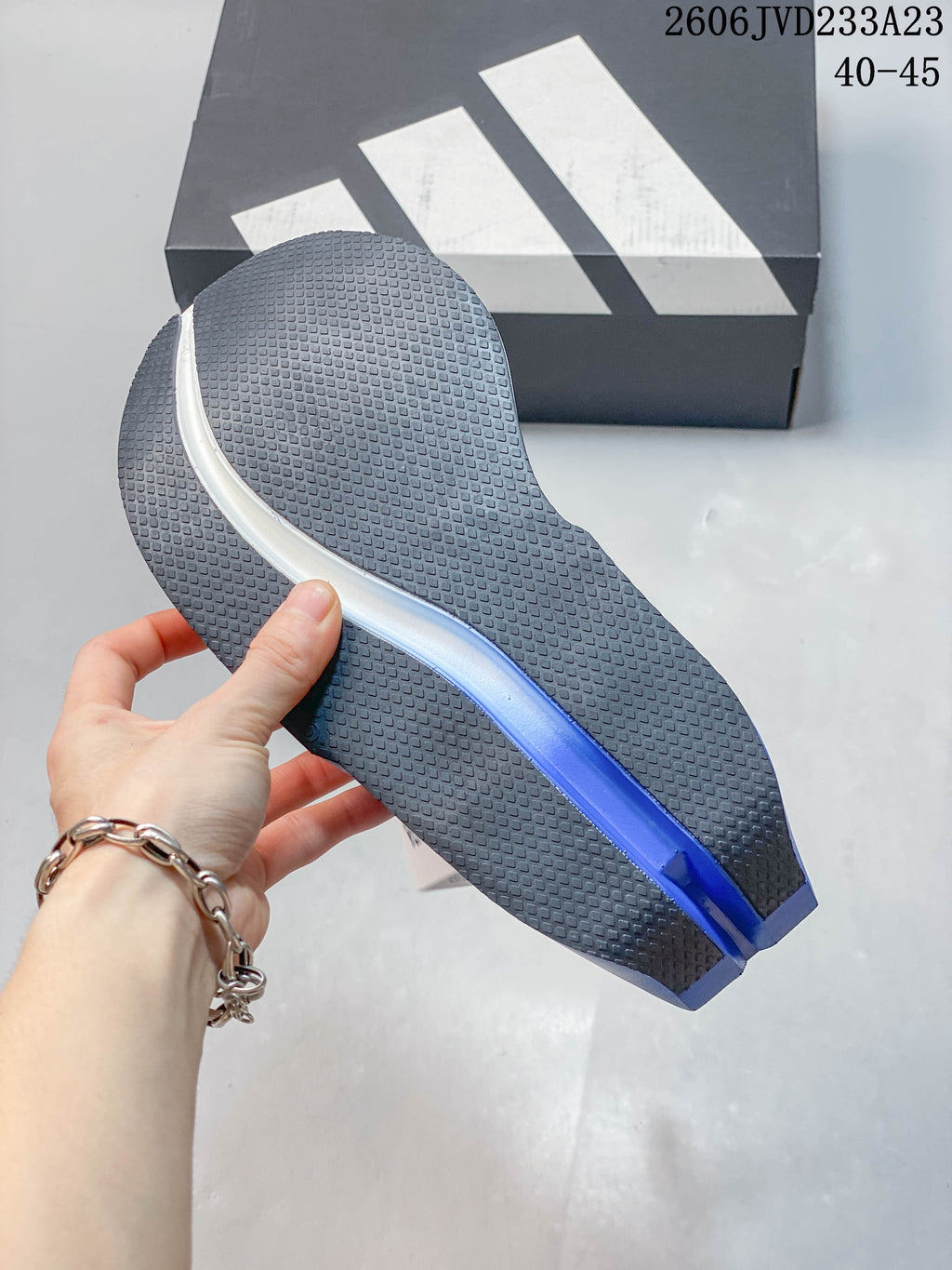 Close-up of the shoe outsole, showing its textured tread and blue center detail