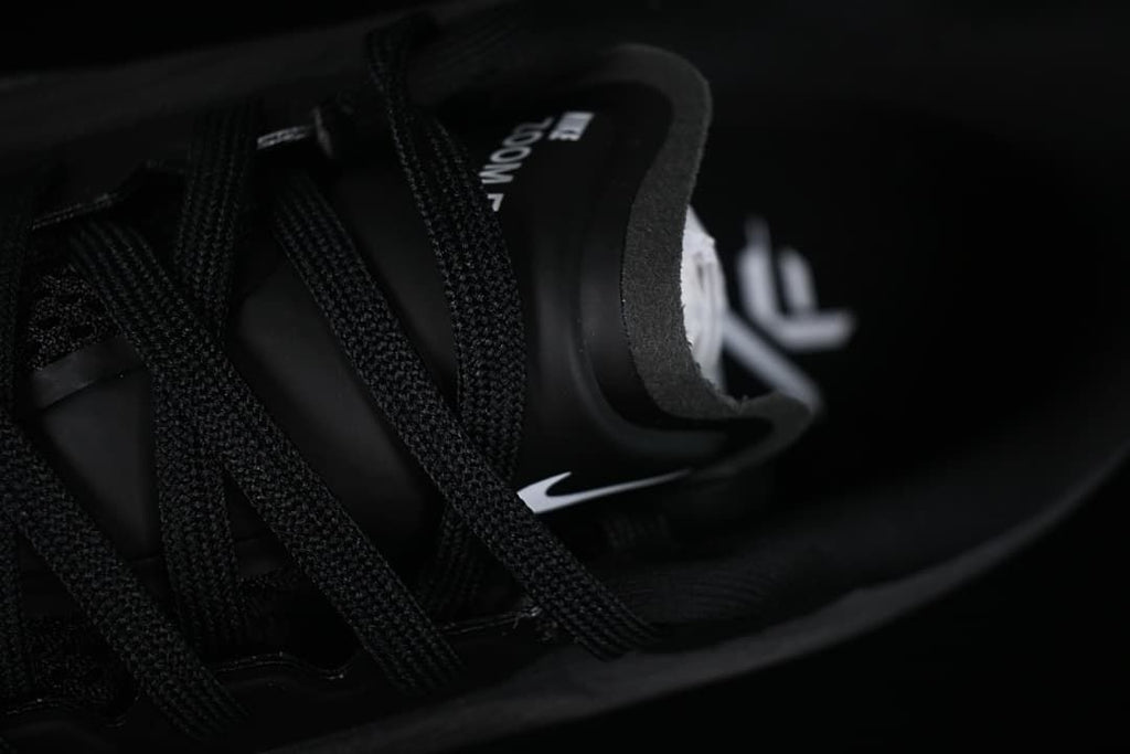 Close-up of the shoe's tongue, laces, and interior branding