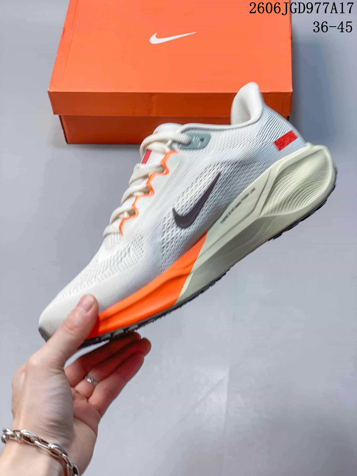Side view of a light-colored Nike Pegasus 41 shoe with orange midsole accents