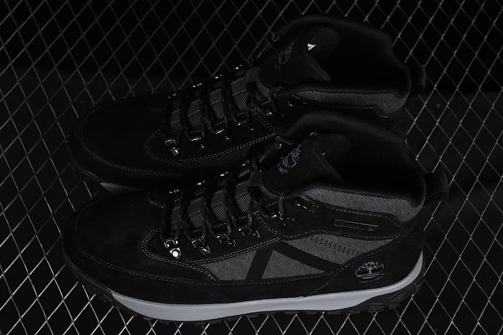 Pair of black and charcoal mid-top boots shown from above and the side.
