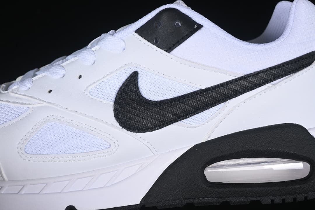 Close-up of the black side swoosh and white mesh-look panels.
