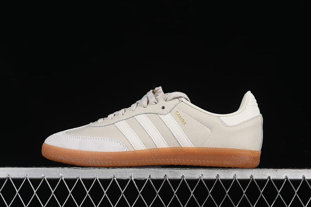 Side view of an off-white adidas Samba OG sneaker with three stripes and a gum outsole