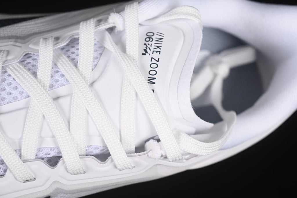 Close-up of the white laces, tongue, and upper.