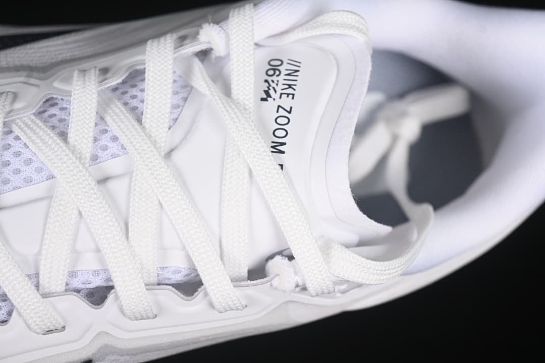 Close-up of the white laces, tongue, and upper.