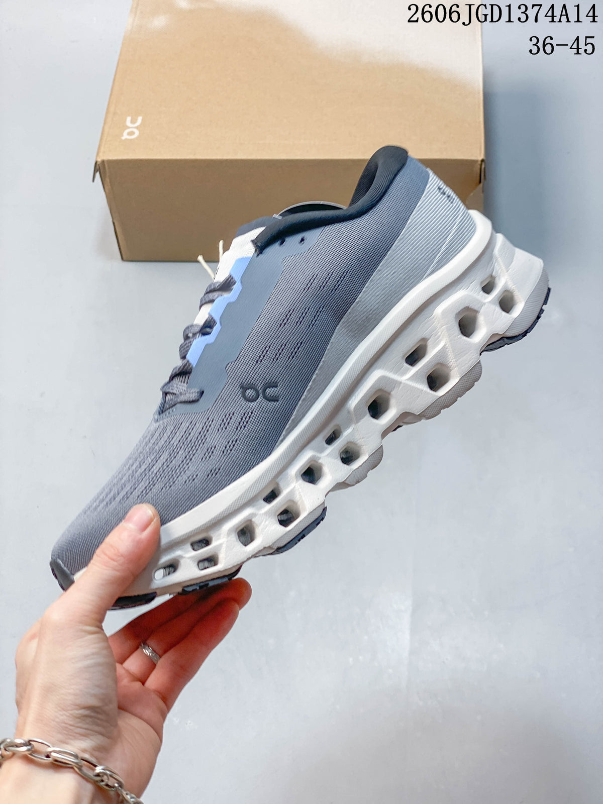 Side view of the grey shoe with light blue details and open sections in the white midsole.
