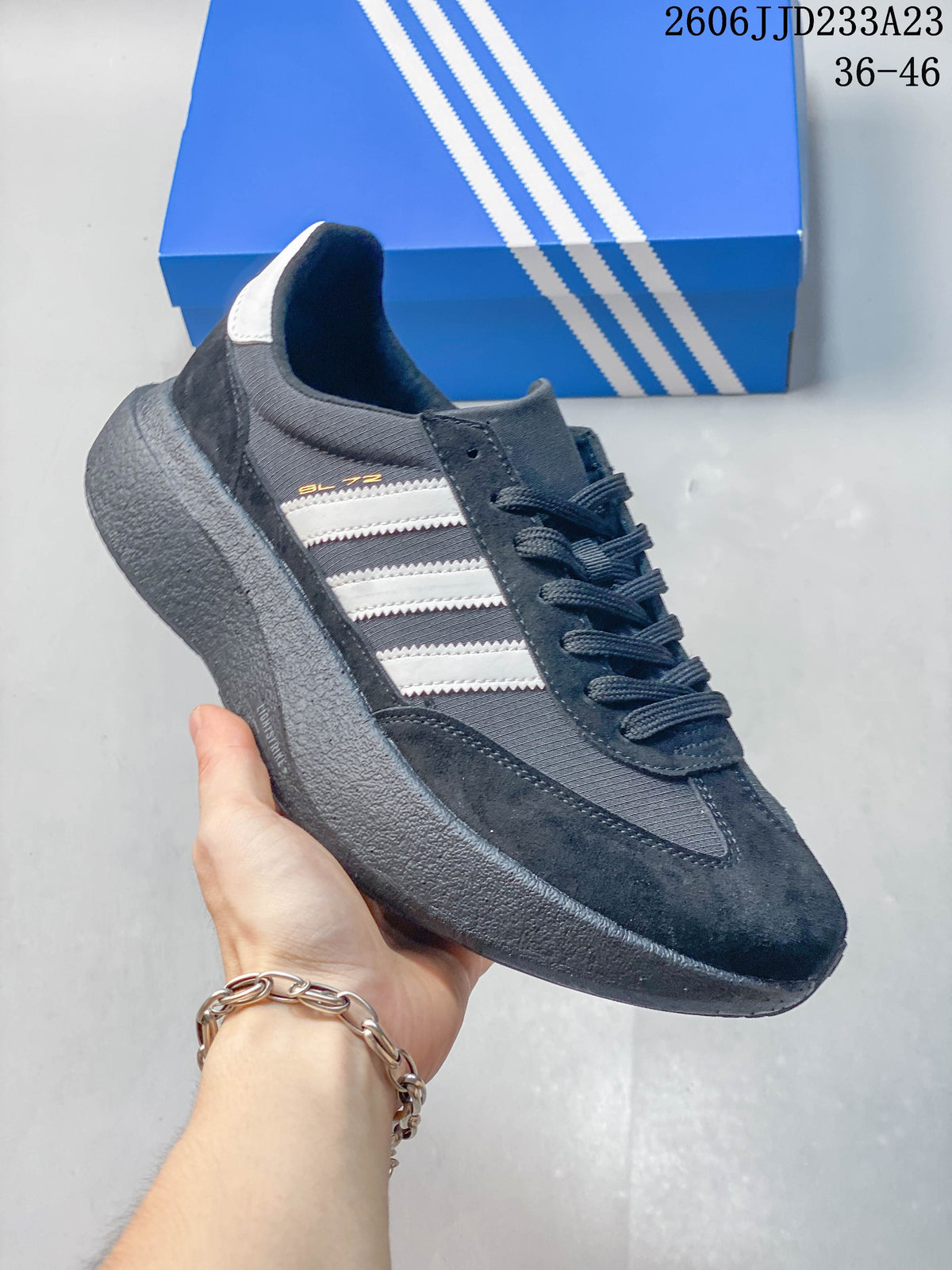 Side view of a grey and black adidas Originals SL 72 Pro sneaker with light-colored stripes.