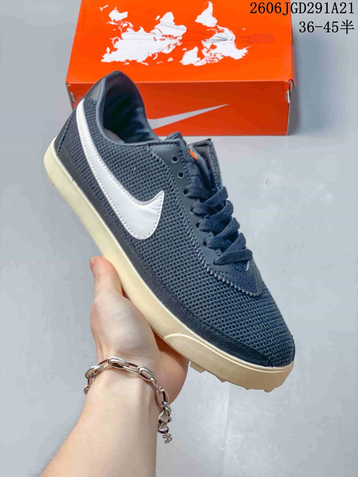 Angled side view of a navy Nike Astrograbber sneaker with a white Swoosh and off-white sole.