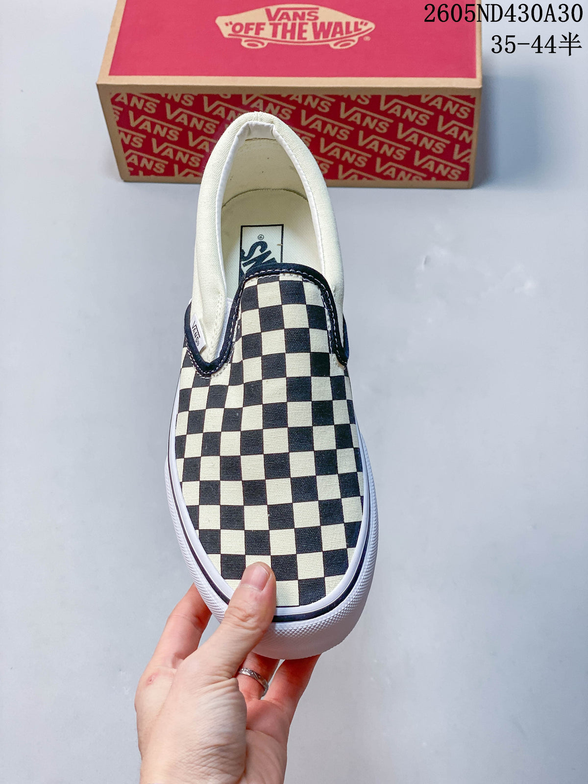 Top view of a checkerboard slip-on sneaker with a white lining.