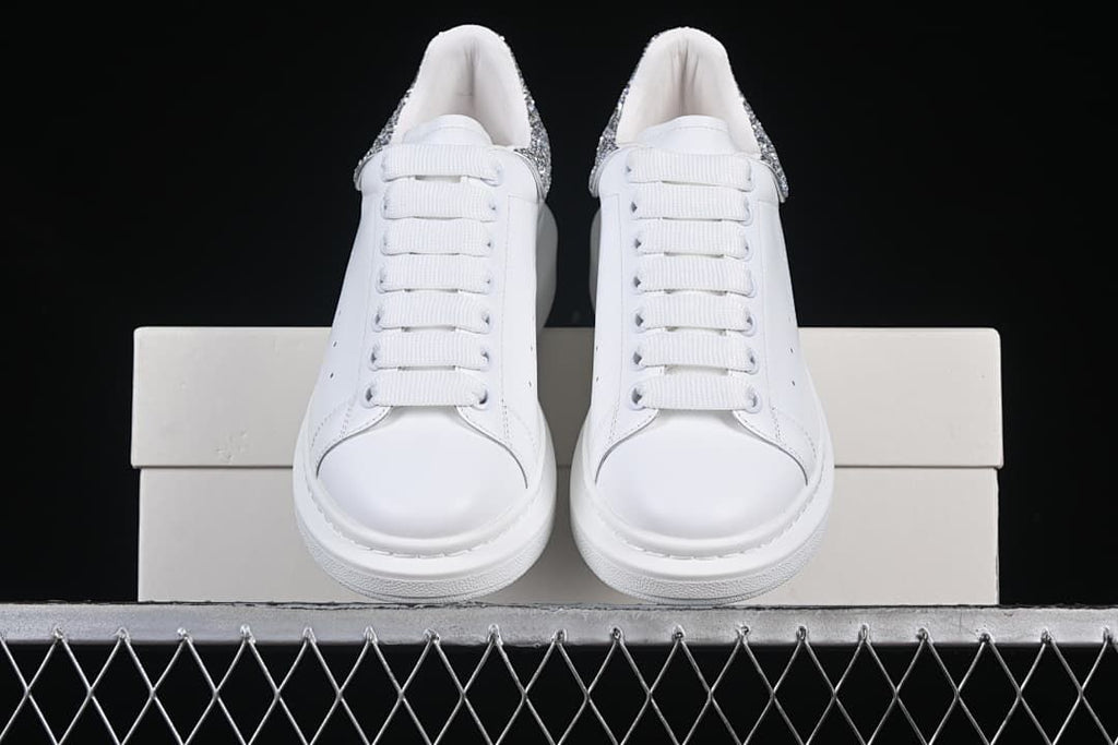 Front view of the pair showing white laces and toe shapes.