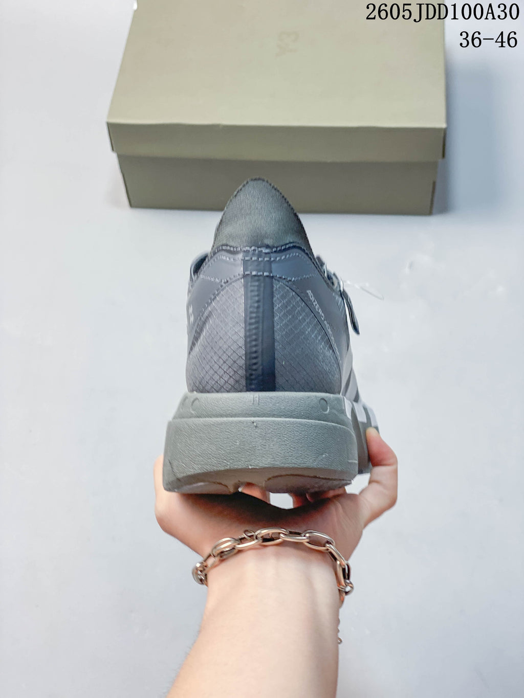 Rear view of the gray running shoe and its sculpted sole.