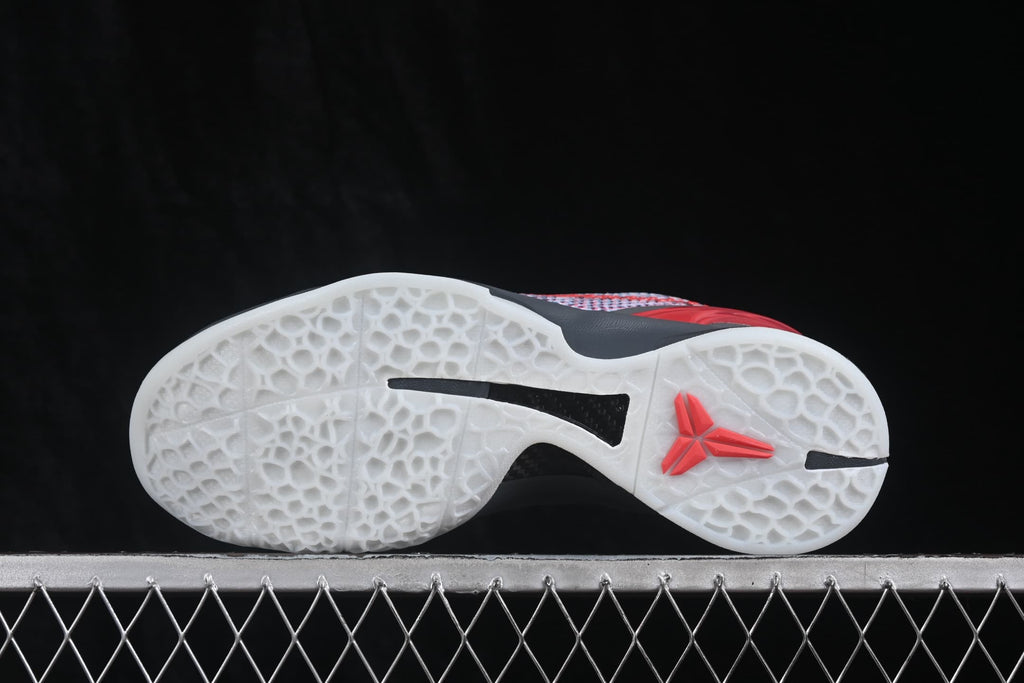Outsole view showing the translucent white traction pattern, black inserts, and red Kobe logo.