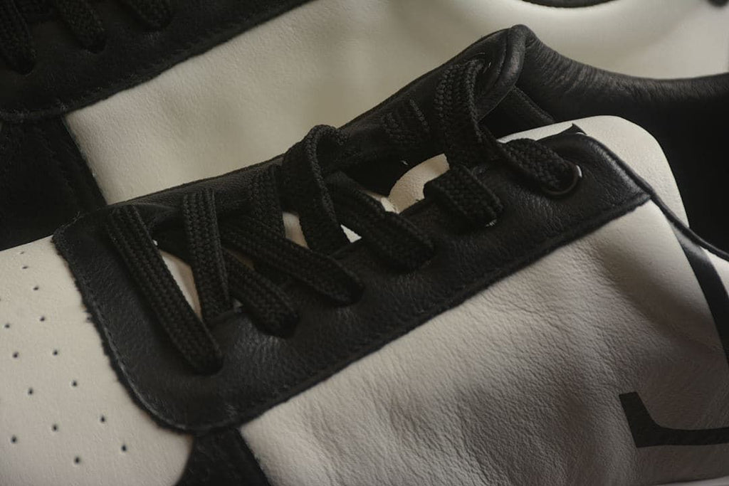 Close-up of the black laces and contrasting upper panels