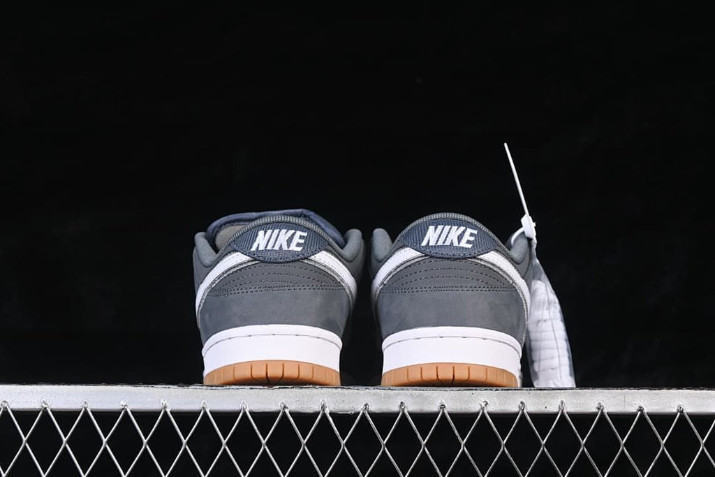 Rear view of the pair showing Nike heel tabs and gum-colored outsoles.