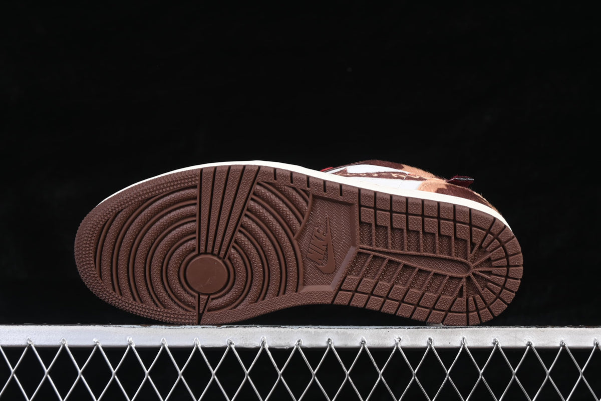 Underside view showing the dark brown outsole tread of the Air Jordan 1 Low.