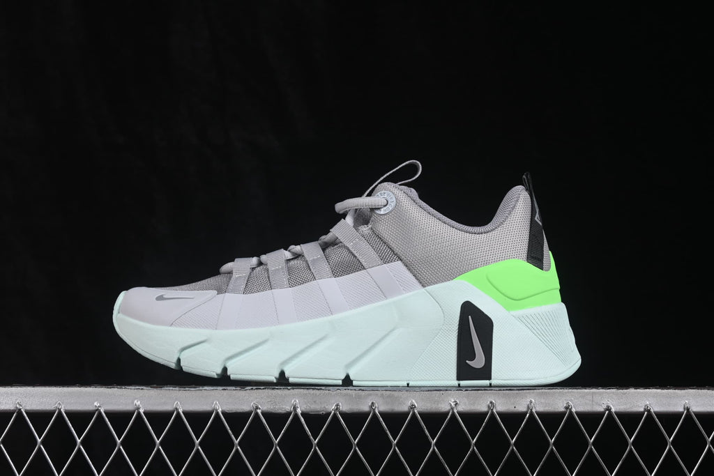 Side profile of the gray, white, and bright green Nike Free Metcon 7 sneaker with a layered outsole.