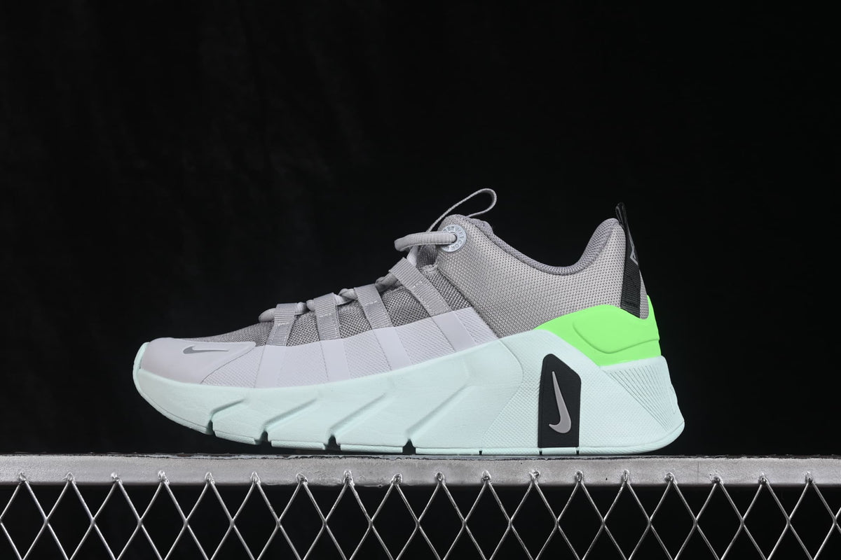 Side profile of the gray, white, and bright green Nike Free Metcon 7 sneaker with a layered outsole.