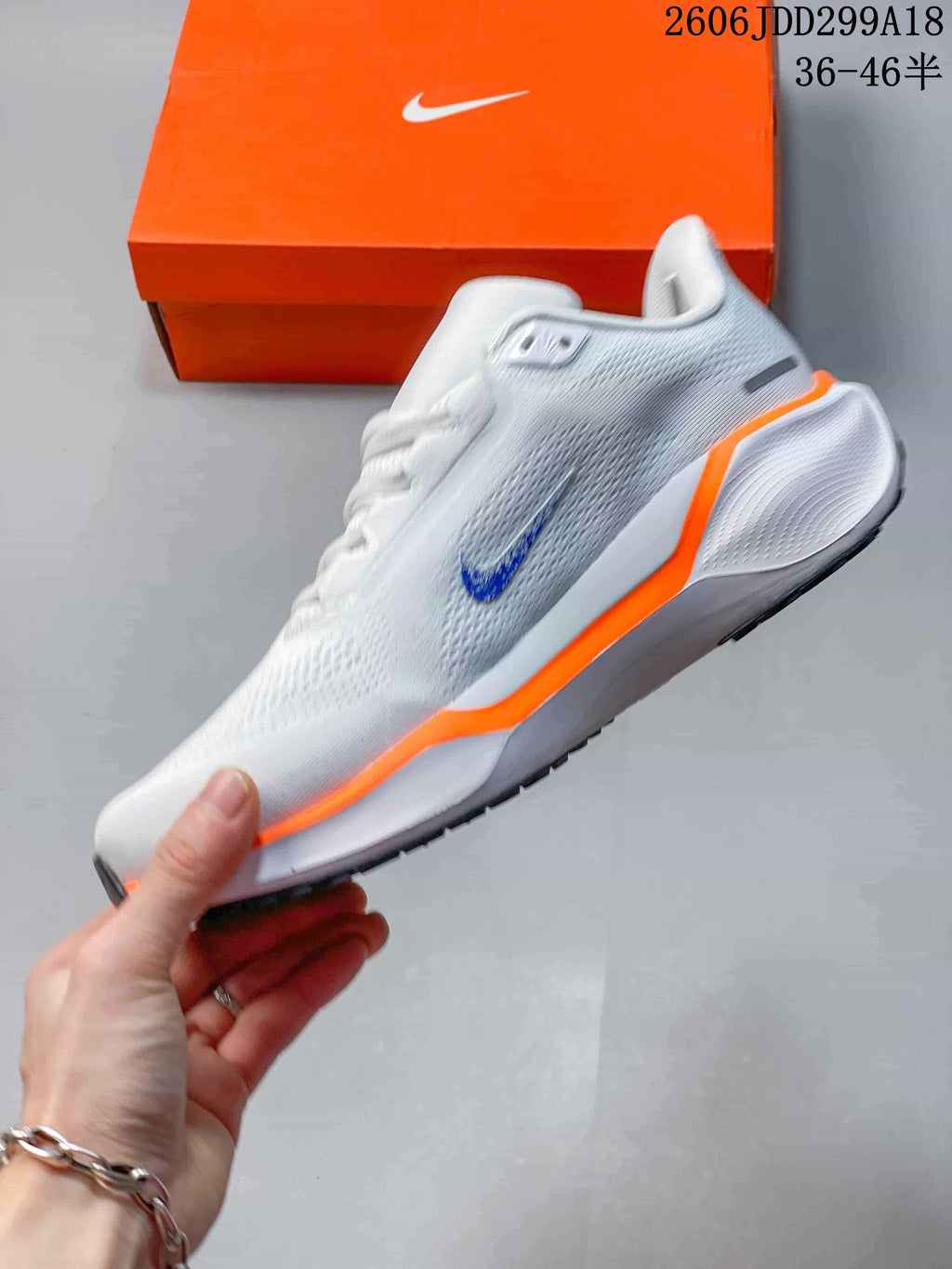 Side profile of a white Nike Pegasus 41 running shoe with a blue Swoosh and orange midsole accent.