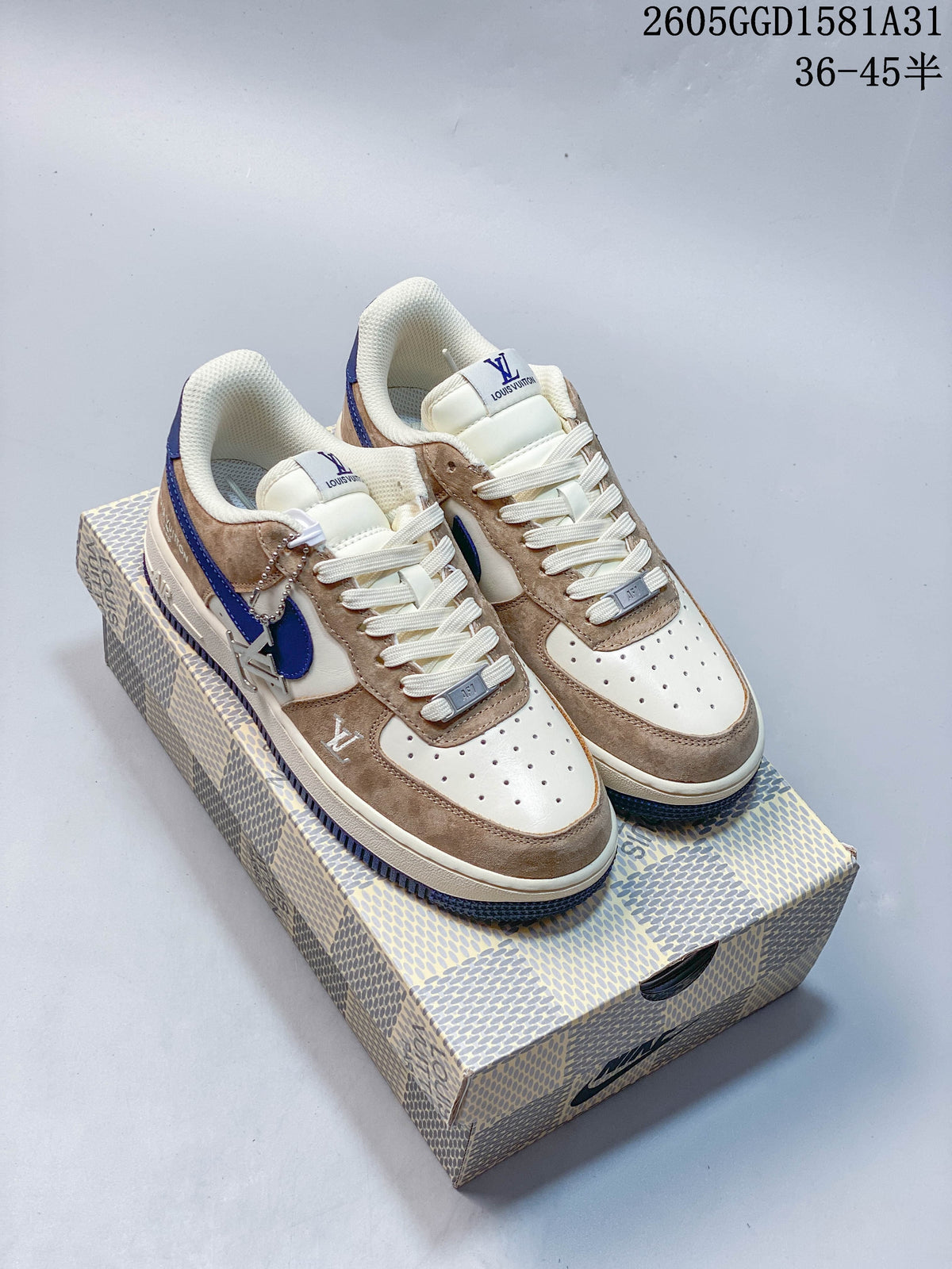 Pair of cream, taupe, and blue low-top Nike sneakers on a patterned box