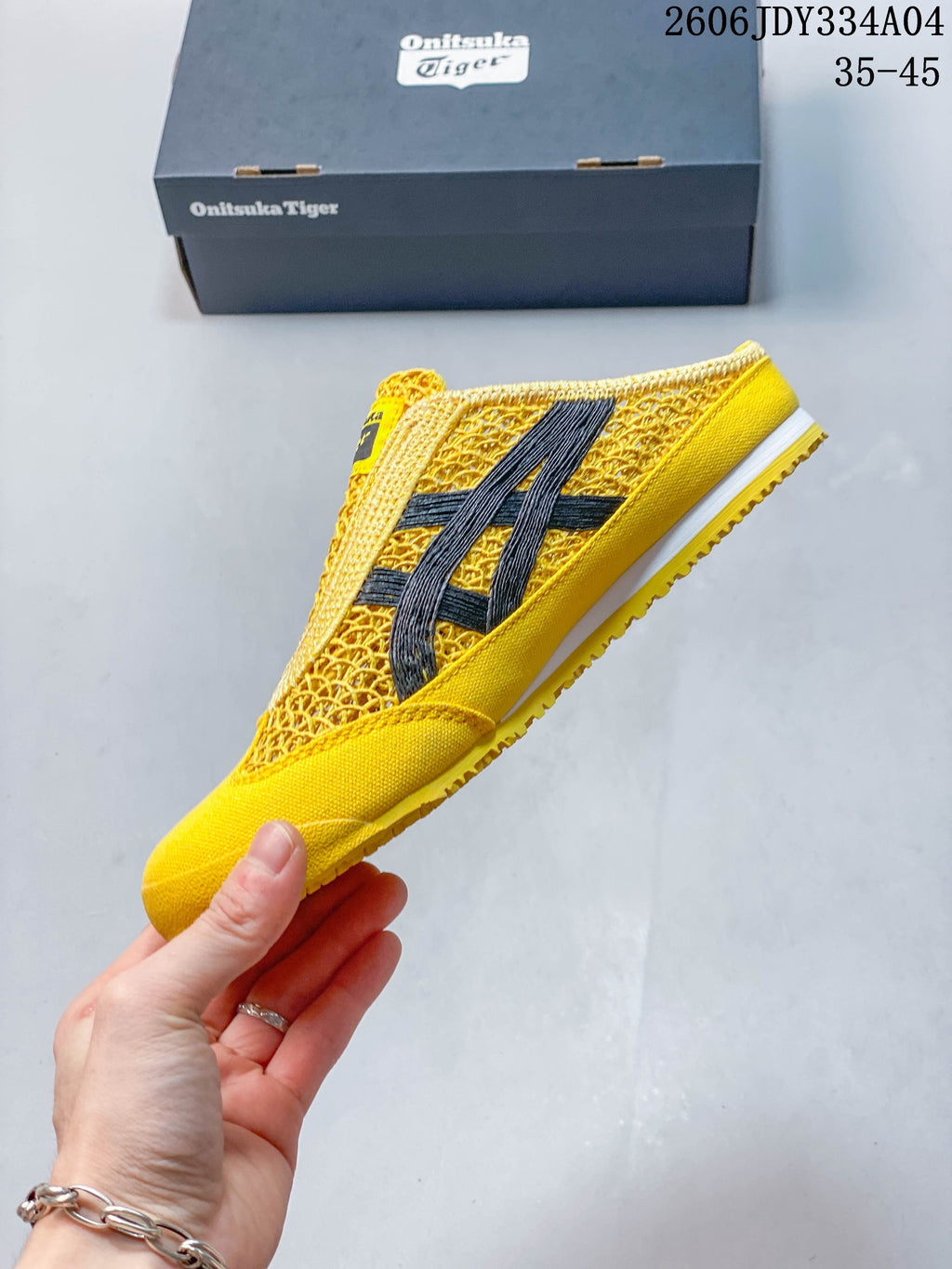 Side profile of the yellow Sabot slip-on with dark stripes and textured panels.