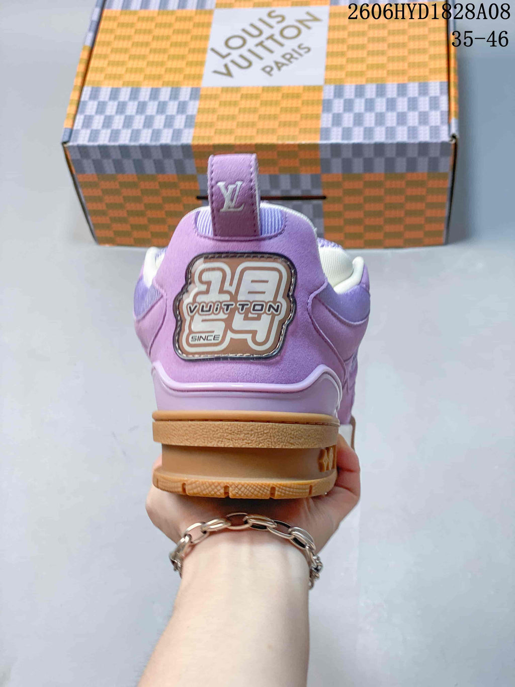 Rear view showing the lavender heel panel and branded decorative patch