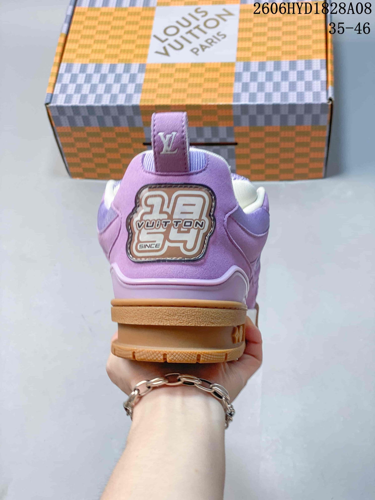 Rear view showing the lavender heel panel and branded decorative patch