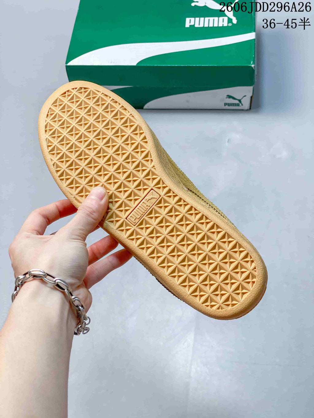 Close-up of the geometric tread on the wheat-colored sneaker outsole