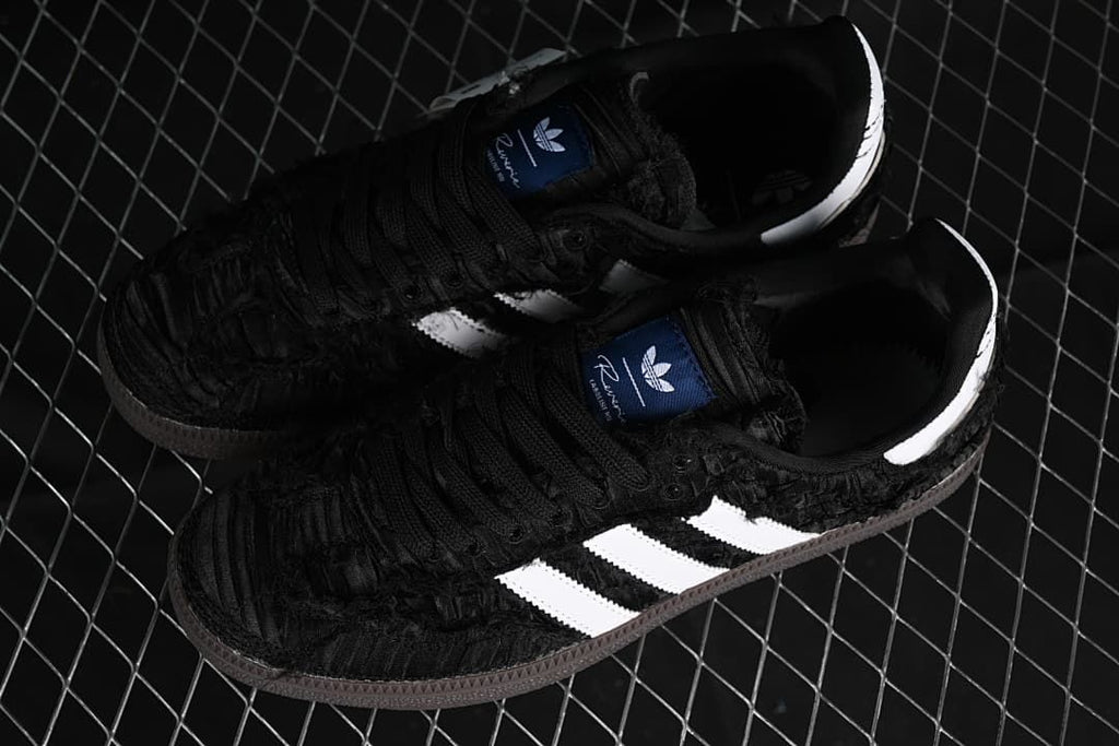 Pair of black Samba OG sneakers with white stripes