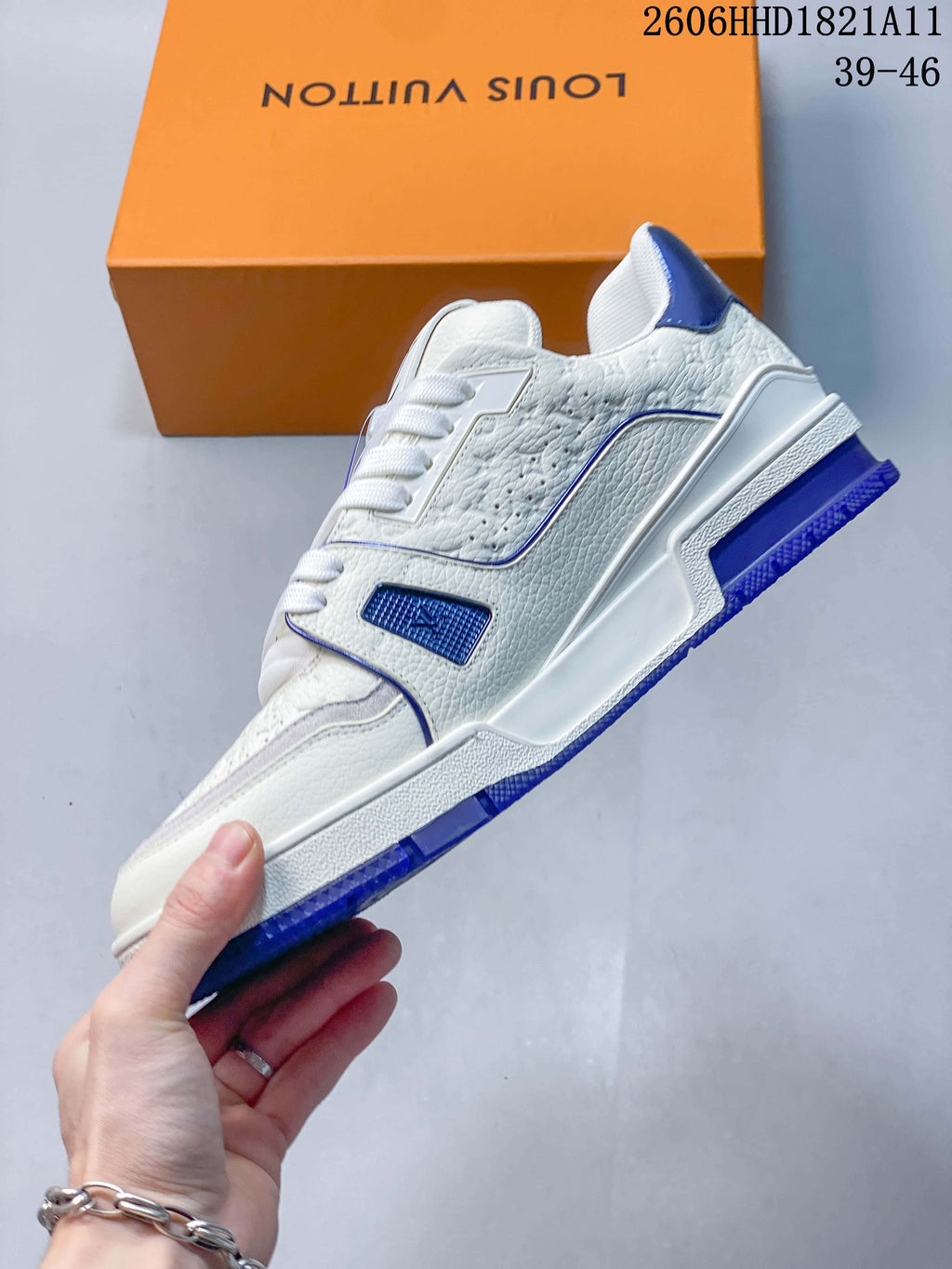 Side view showing the white textured upper, blue accents, and outsole.