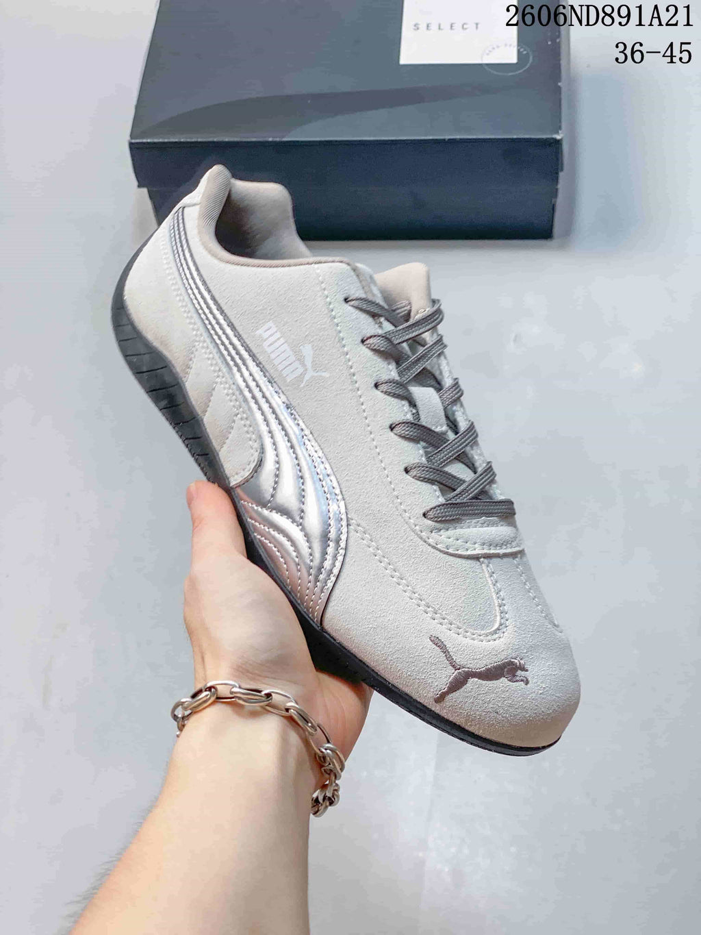 Side view of a light gray Puma Speedcat OG sneaker with gray laces and a dark outsole.