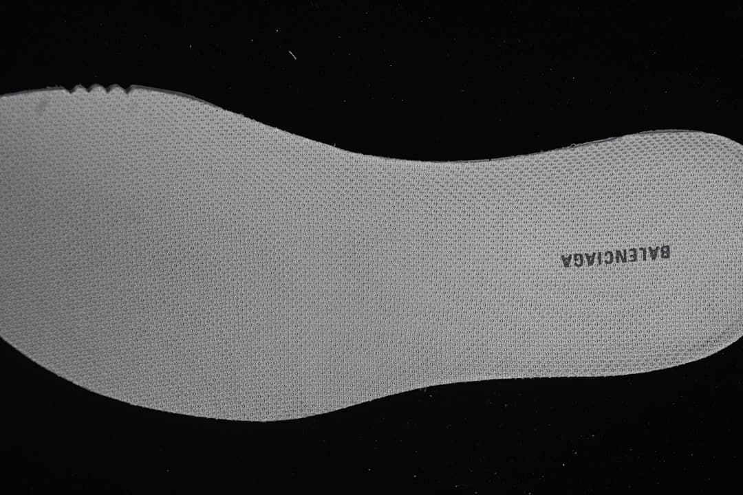 Close-up of the textured shoe insole with branding