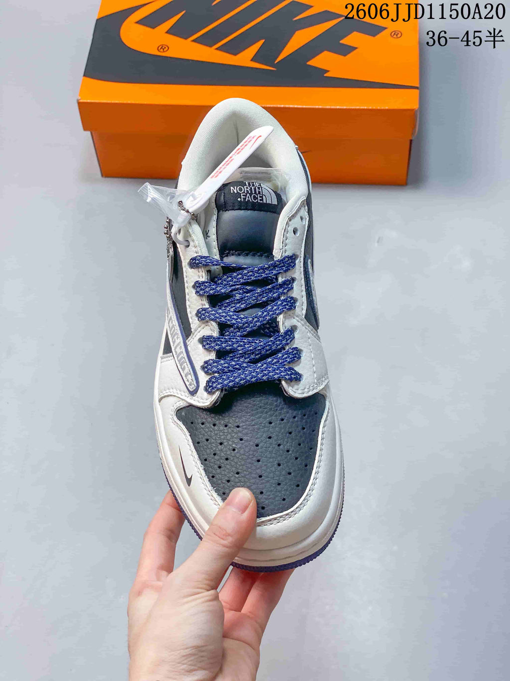 Top view showing the perforated dark toe panel, white overlays, and blue laces.
