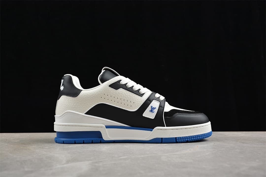 Side profile of a white and black LV Trainer with blue outsole
