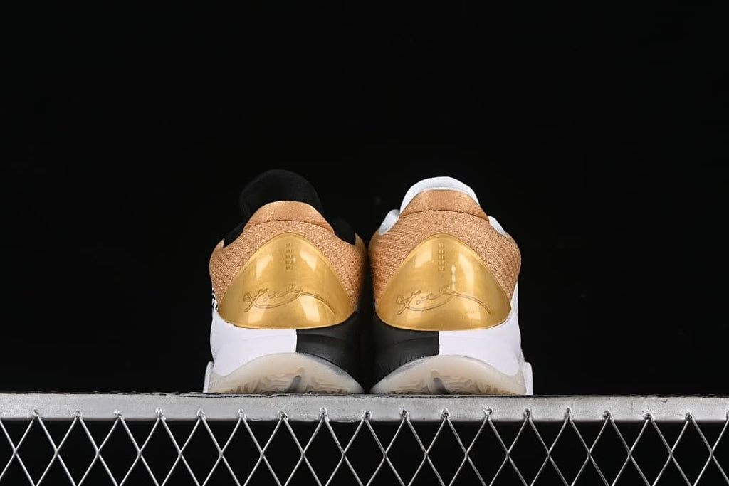 Rear view of the pair showing gold heel panels and Kobe signatures