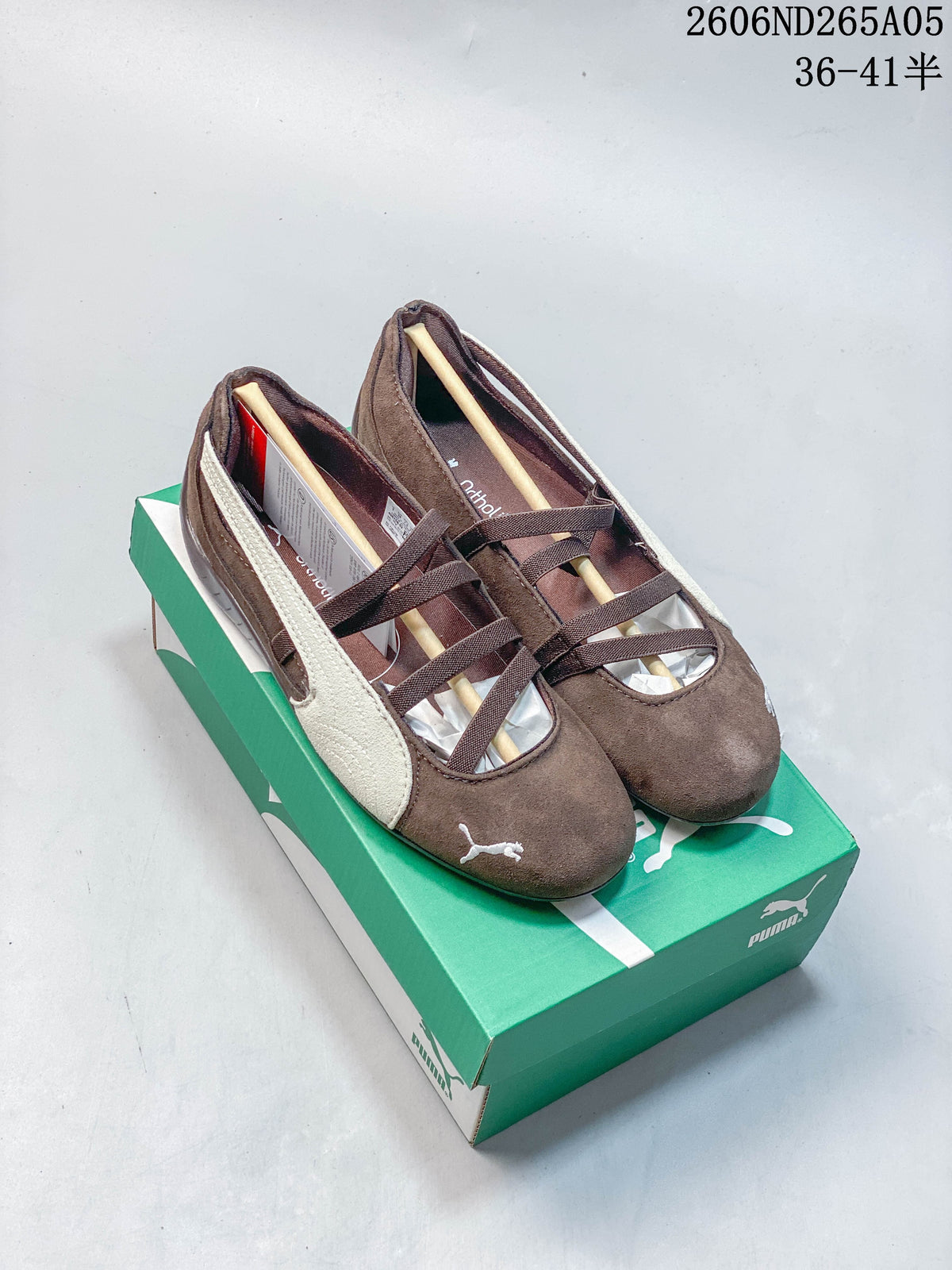 Pair of brown PUMA Speedcat Ballet shoes with cream side stripes and crossed elastic bands