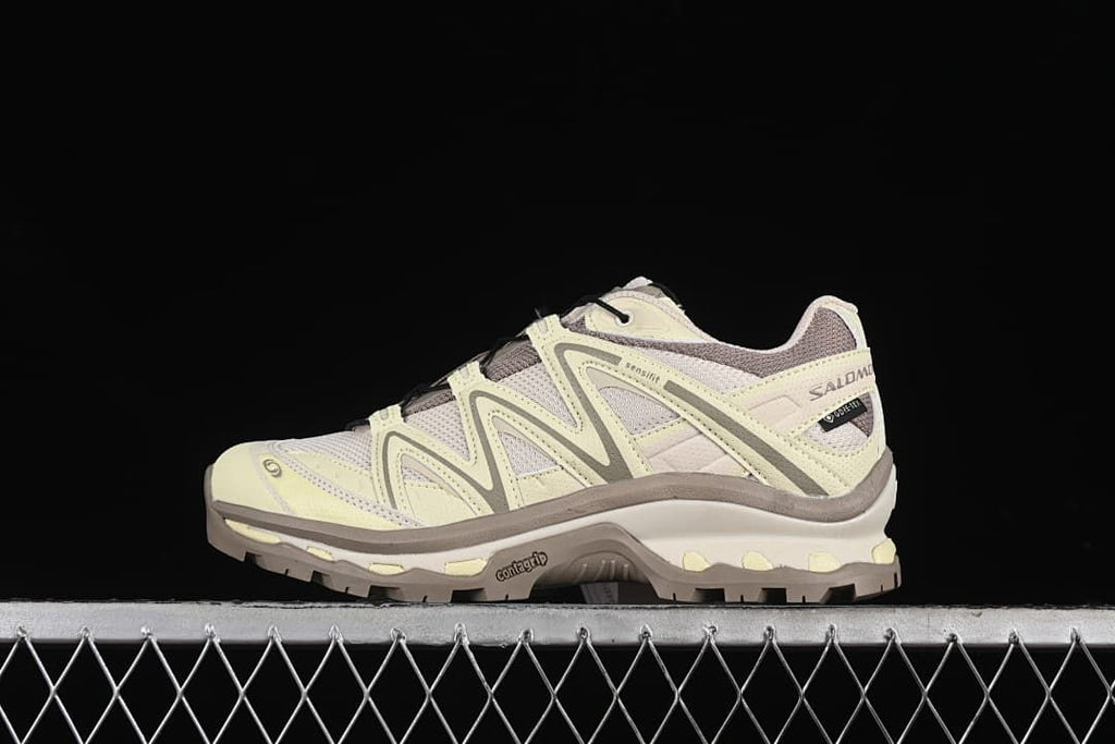 Side view of pale yellow and taupe Salomon XT-Quest trail shoe