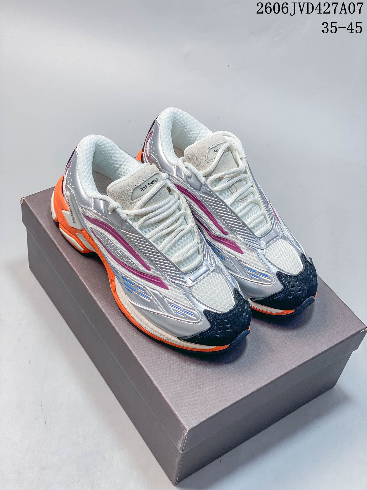 Pair of silver, white, magenta, and orange Raf Simons Cylon-21 low-top sneakers on a box; image overlay shows 35–45.