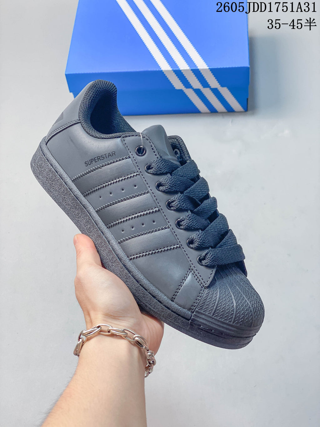 Gray sneaker with matching stripes, laces and shell toe