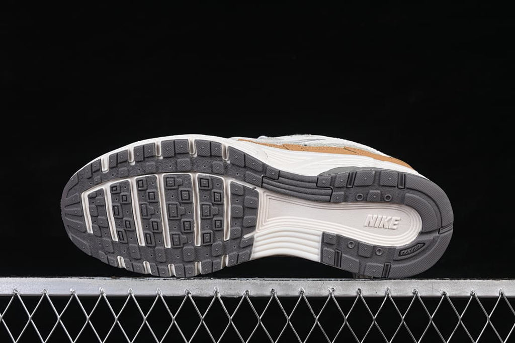 Underside view of the sneaker outsole in dark gray and white