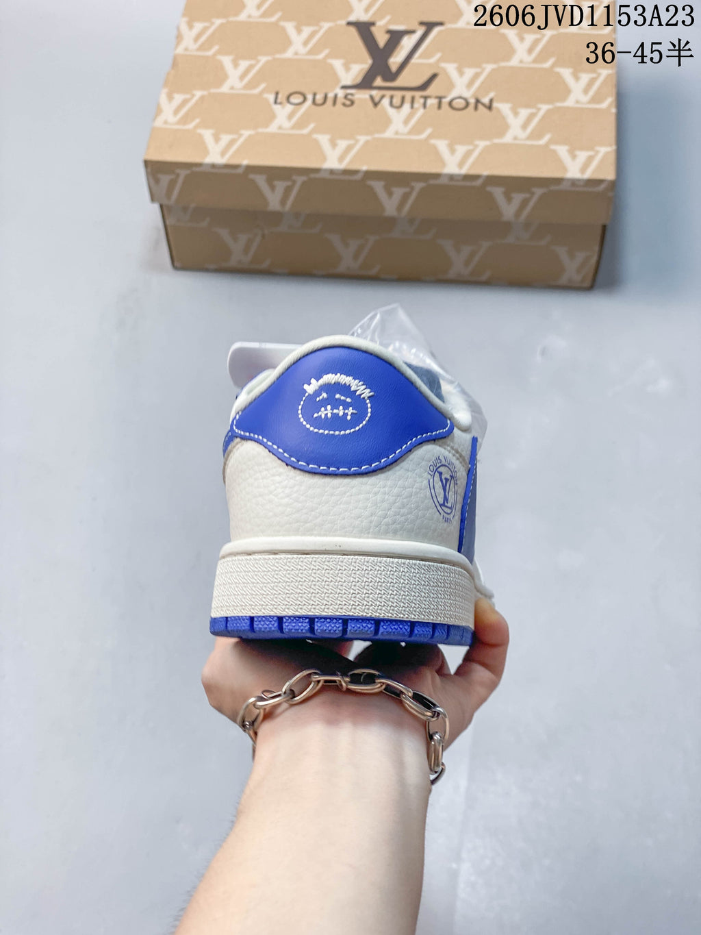 Rear view showing the blue heel panel and off-white upper