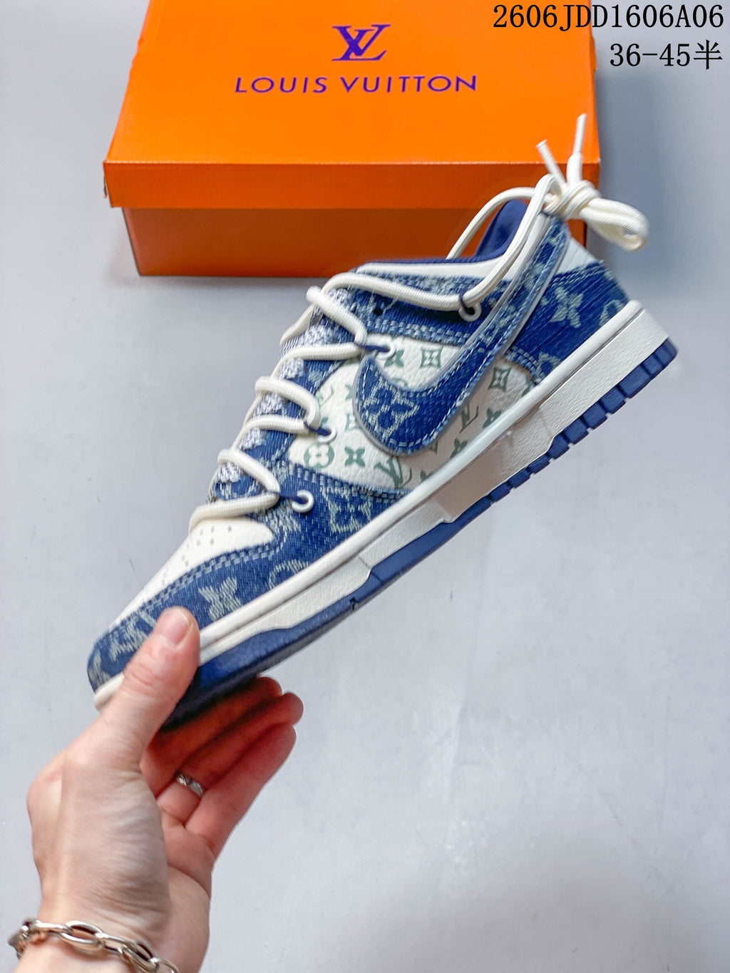 Side profile showing blue patterned panels, cream monogram-style section, and Swoosh