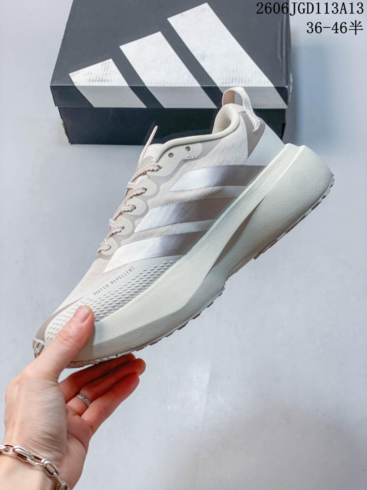 Side view of a light grey Adidas Adizero Pro Evo SL ATR shoe with three stripes