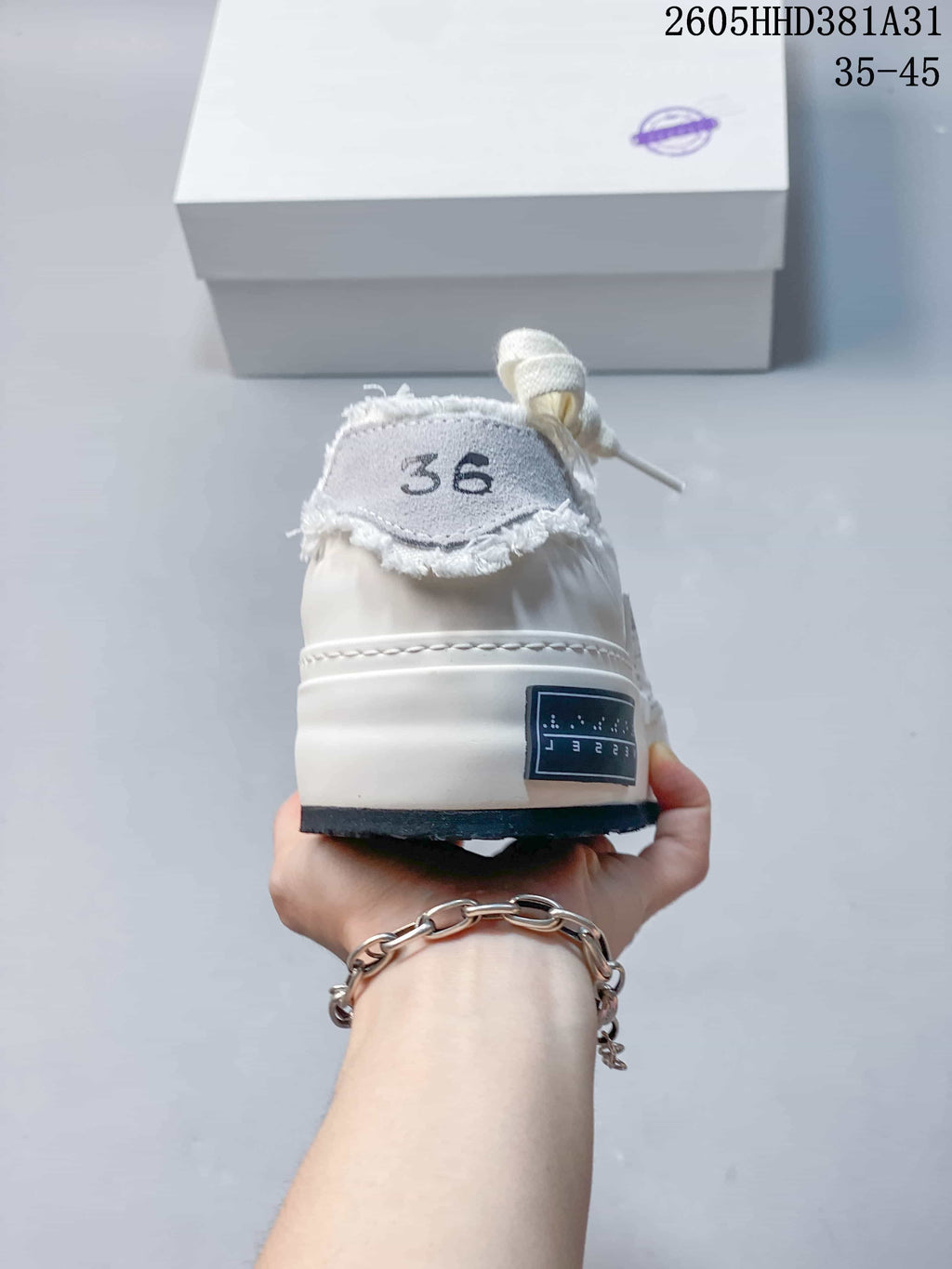 Rear view of a white xVESSEL G.O.P. Low sneaker showing the size 36 marking