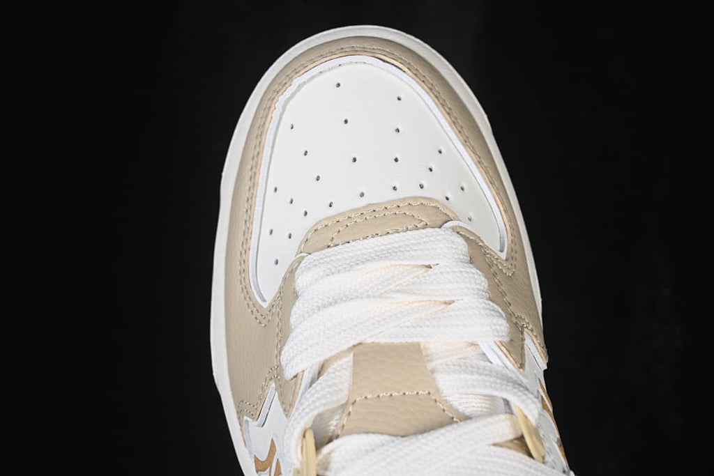 Top view of the sneaker toe box with perforations and white laces