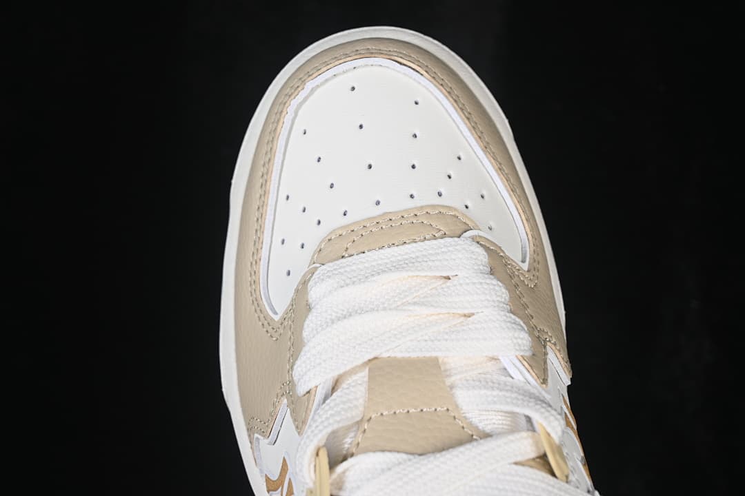 Top view of the sneaker toe box with perforations and white laces