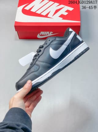 Side profile of a black and white Nike low-top sneaker showing the Swoosh and layered outsole.