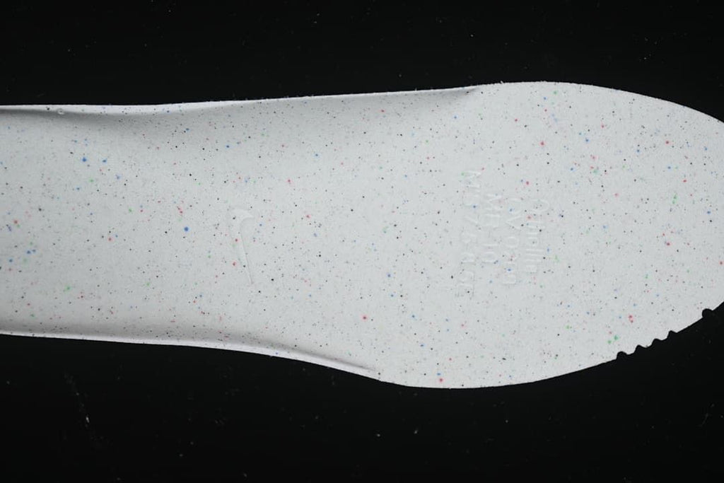 Close-up of the shoe's light-colored outsole with speckled details