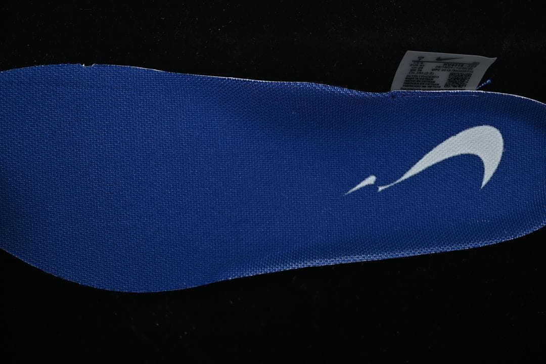 Close-up of a blue shoe insert with a white logo
