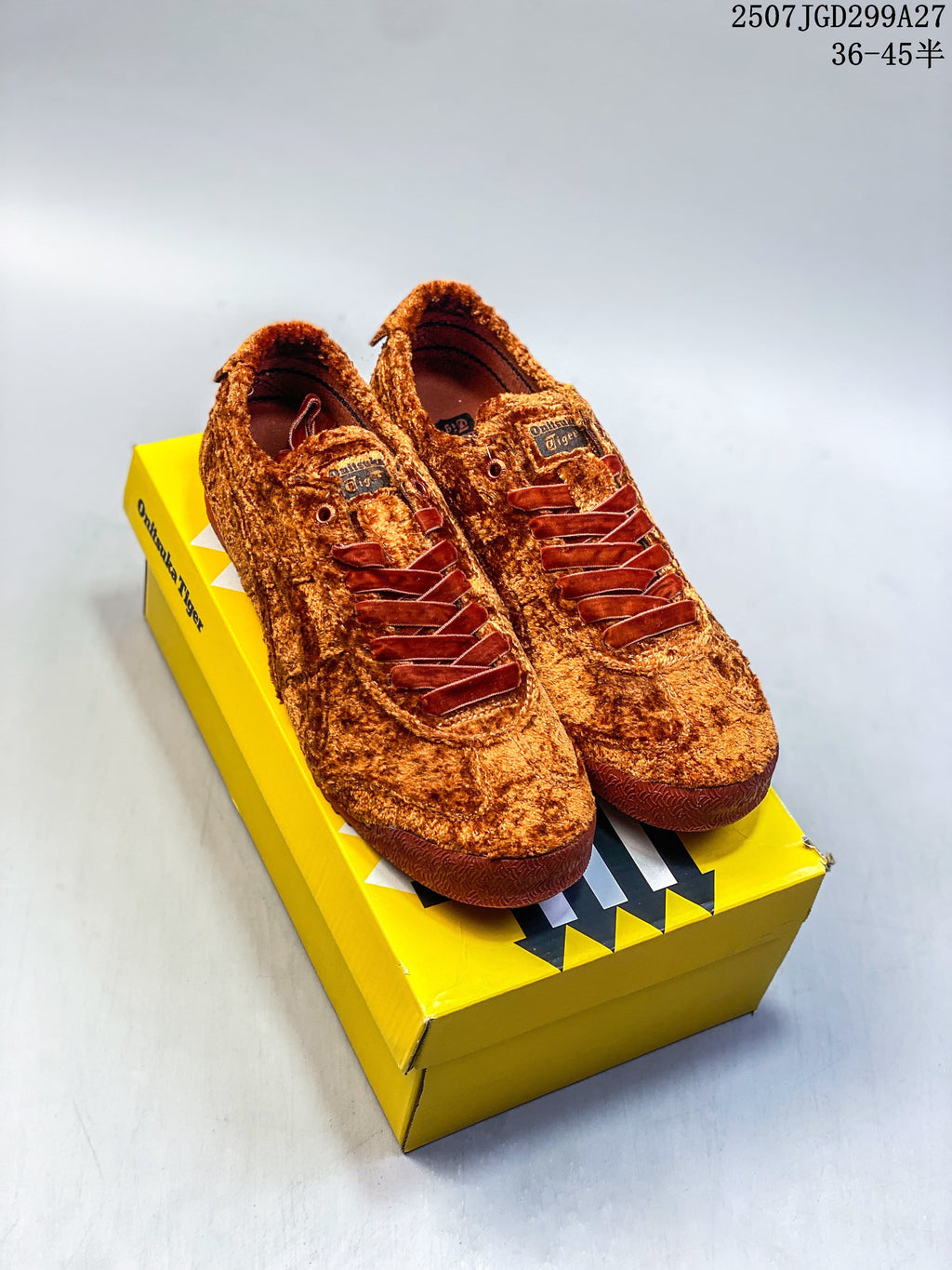 Pair of rust-brown Onitsuka Tiger Mexico 66 SD Paraty sneakers displayed on a yellow shoebox