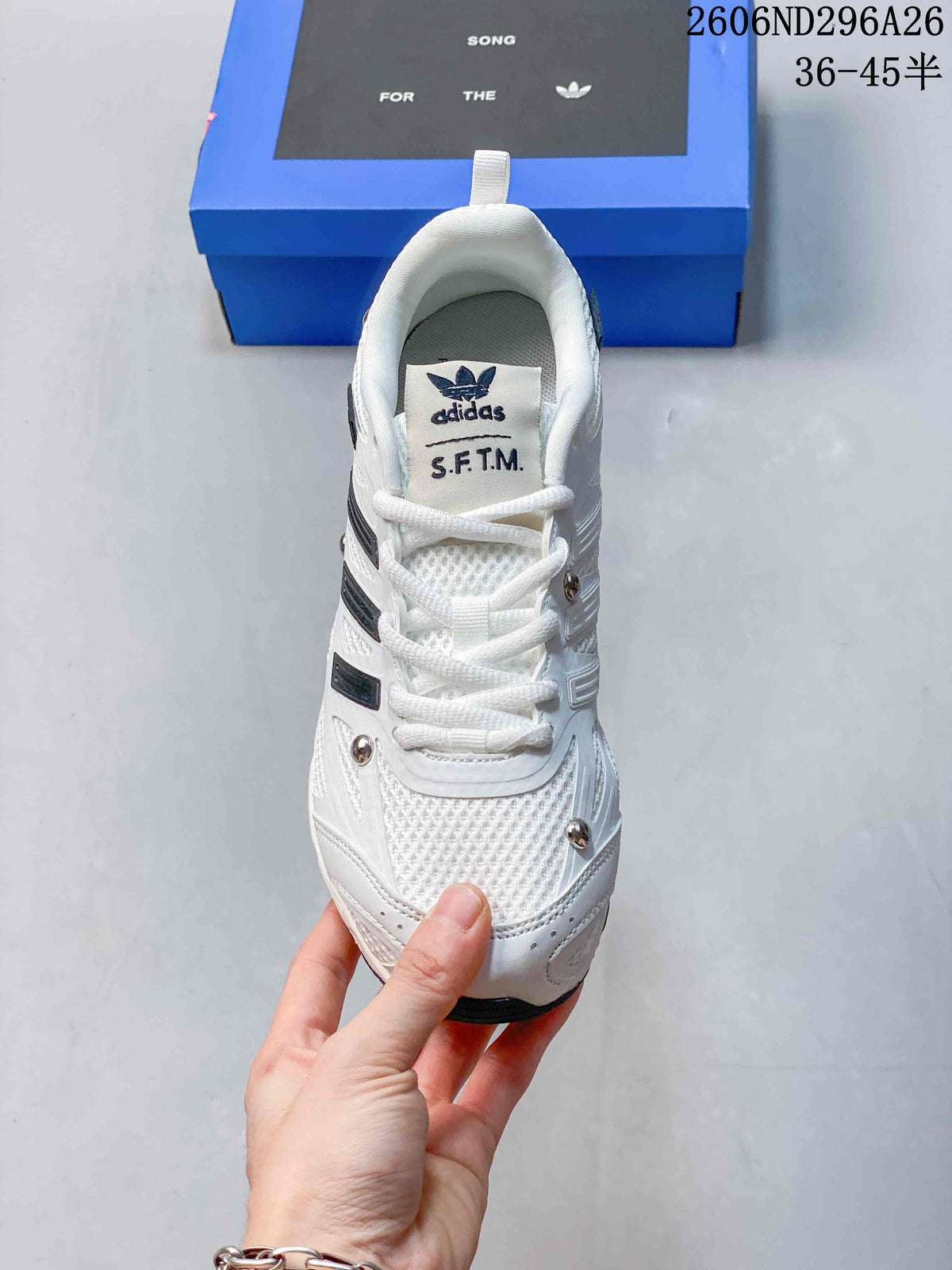 Top view of the white lace-up sneaker with S.F.T.M. tongue label